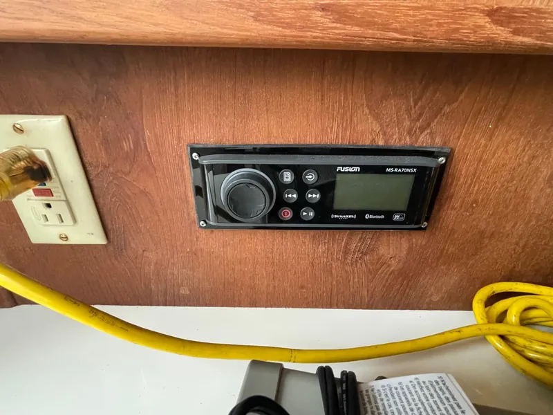 Slide: The Image of Fusion stereo system on a 2003 Carolina Classic 28 boat, with yellow cable and outlet. - 23