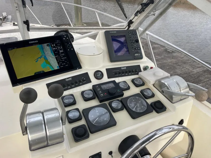 Slide: The Image of Control panel of a 2003 Carolina Classic 28 boat with navigation equipment. - 24