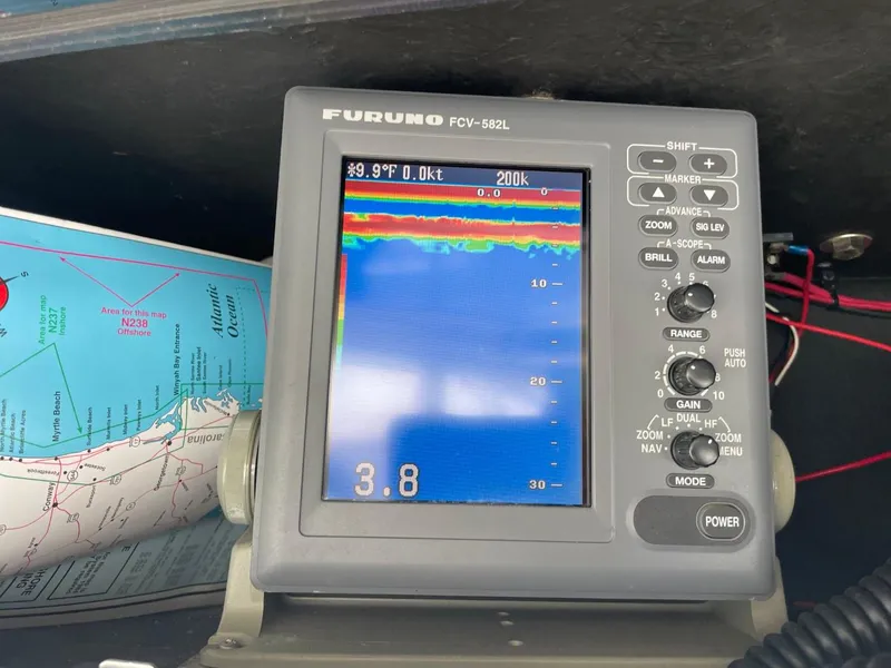 Slide: The Image of Fish finder display on a 2003 Carolina Classic 28 boat, showing depth and sonar readings. - 26