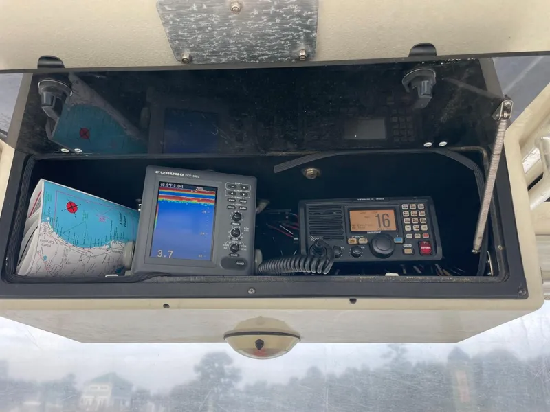 Slide: The Image of 2003 Carolina Classic 28 boat dashboard with navigation equipment and radio. - 27
