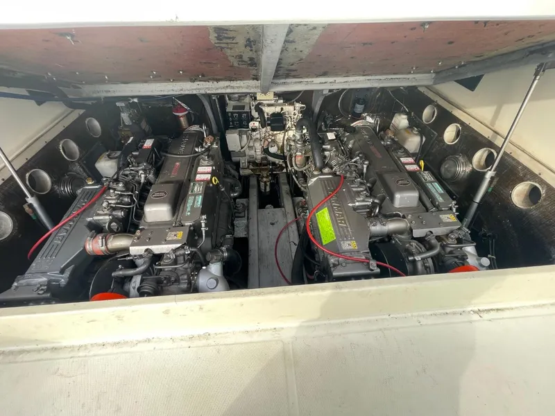 Slide: The Image of Engine compartment of a 2003 Carolina Classic 28 boat, showcasing dual engines. - 31