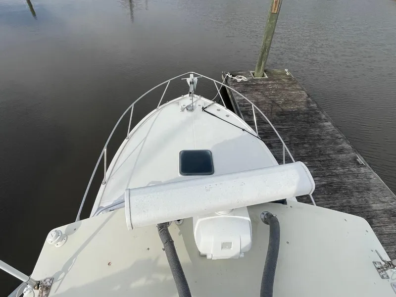 Slide: The Image of 2003 Carolina Classic 28 boat docked at a wooden pier, top view. - 34