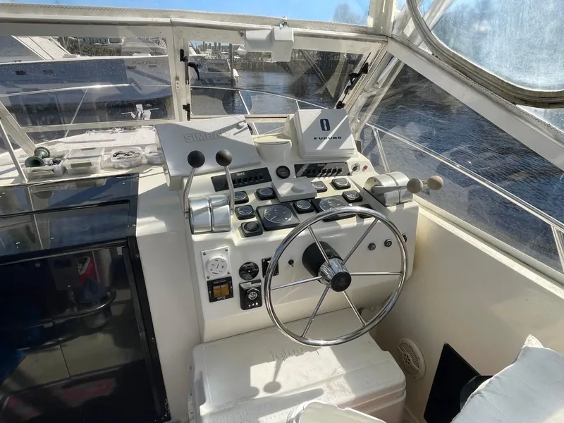 Slide: The Image of 2003 Carolina Classic 28 boat cockpit with steering wheel and control panel. - 40
