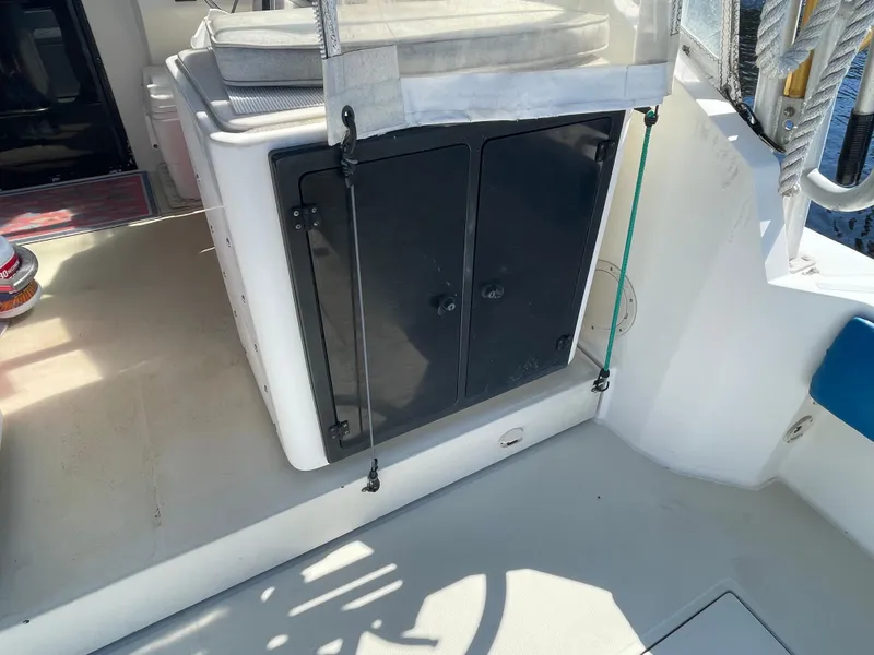 Slide: The Image of 2003 Carolina Classic 28 boat interior with storage compartment and seating area. - 44