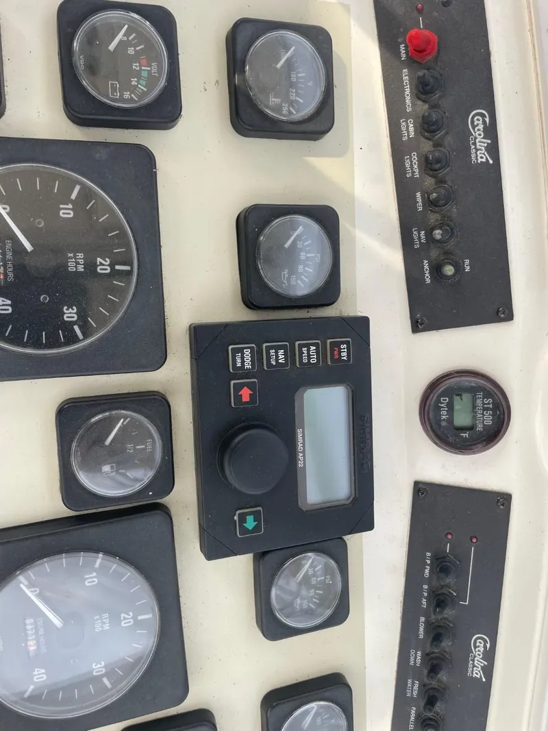 Slide: The Image of Dashboard of a 2003 Carolina Classic 28 boat with various gauges and controls. - 6
