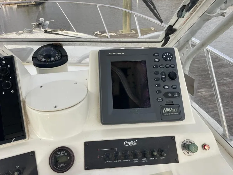 Slide: The Image of Control panel of a 2003 Carolina Classic 28 boat with navigation equipment. - 8