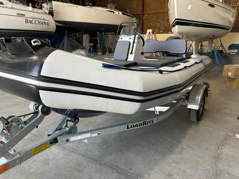 Slide: The Image of 2025 Zodiac Open 4.2 inflatable boat on Load Rite trailer in a storage facility. - 2