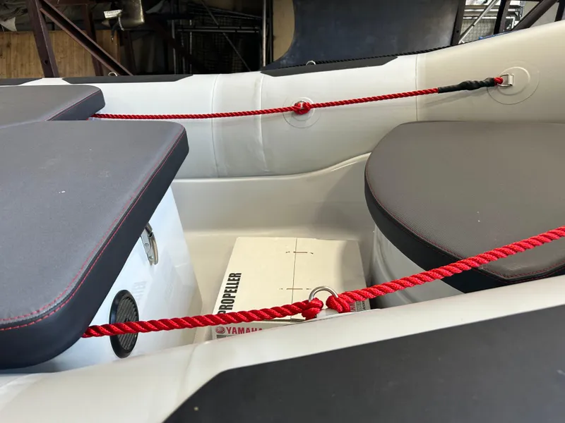 Slide: The Image of 2025 Zodiac Open 4.2 boat interior with red ropes and seating. - 5