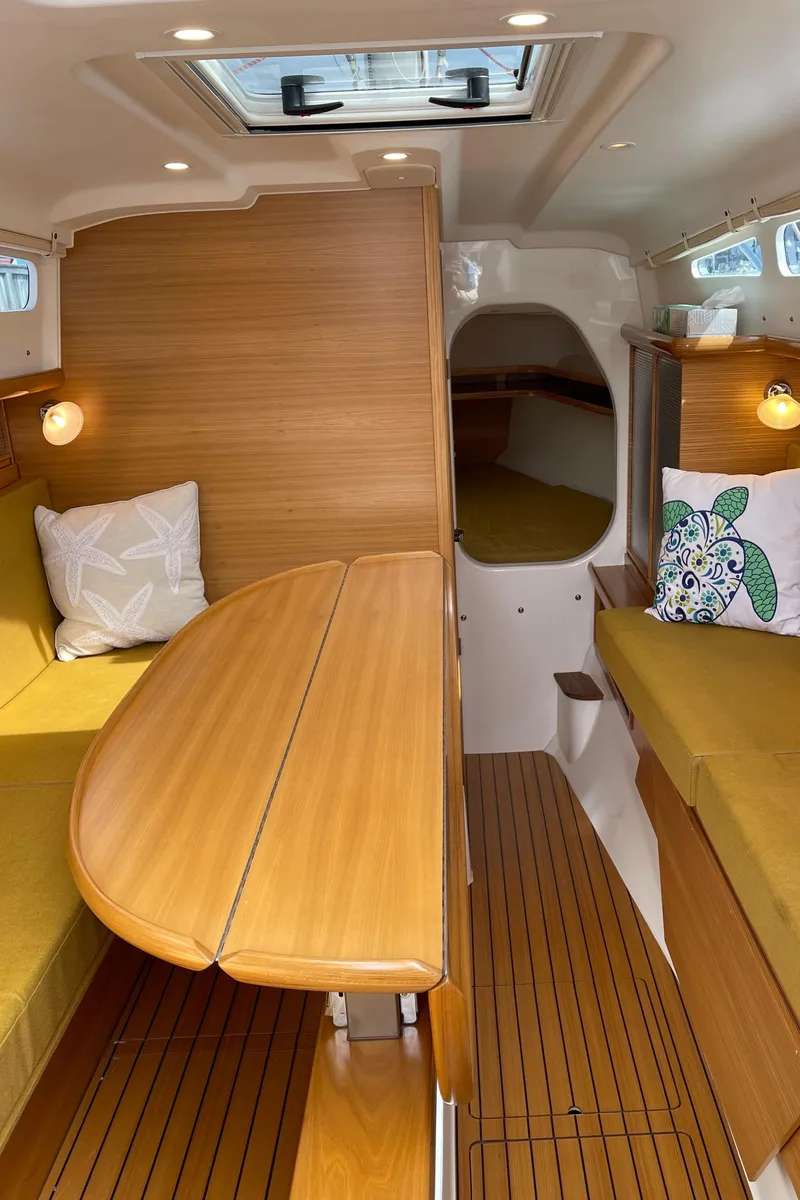Slide: The Image of Interior of 2021 Dragonfly 32 Evolution sailboat with wooden finishes and cozy seating. - 11