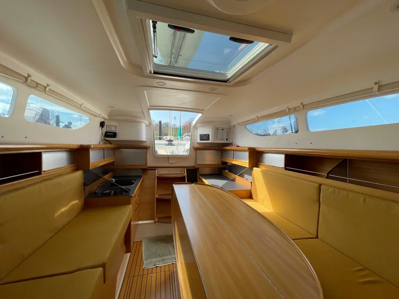 Slide: The Image of Interior of 2021 Dragonfly 32 Evolution sailboat with wooden furnishings and skylight. - 12