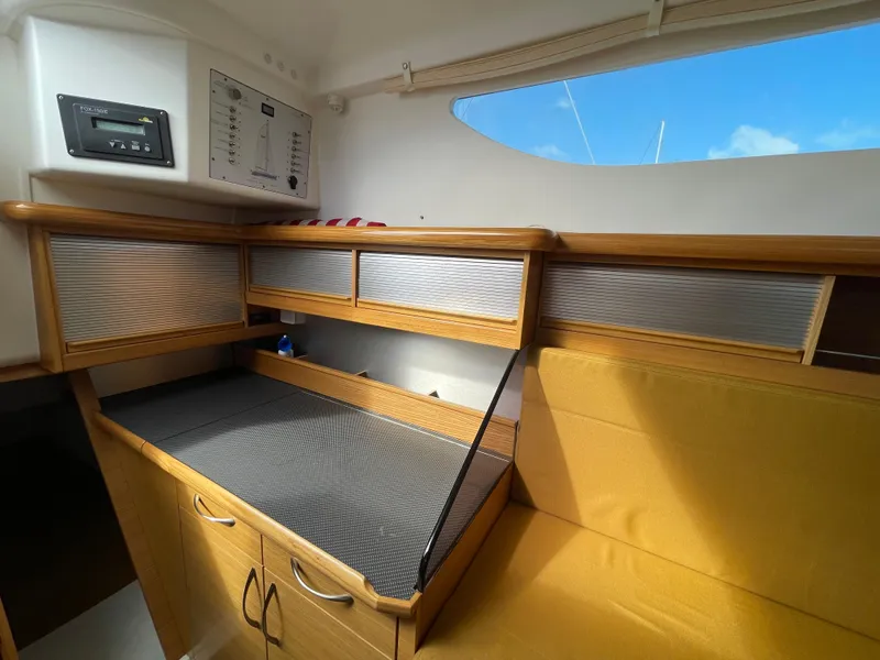 Slide: The Image of Interior of 2021 Dragonfly 32 Evolution sailboat with wooden cabinetry and seating. - 14