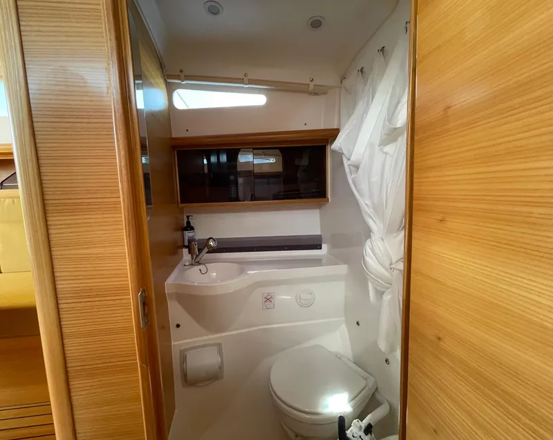 Slide: The Image of Modern bathroom in 2021 Dragonfly 32 Evolution yacht with wooden accents and compact design. - 20