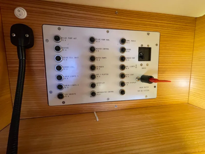 Slide: The Image of Control panel inside 2021 Dragonfly 32 Evolution boat, featuring multiple switches and a wooden finish. - 23