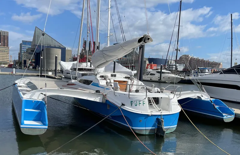 Slide: The Image of 2021 Dragonfly 32 Evolution trimaran docked in a marina under a clear blue sky. - 4