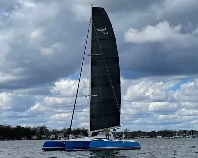 Slide: The Image of 2021 Dragonfly 32 Evolution sailboat on water under cloudy sky. - 6