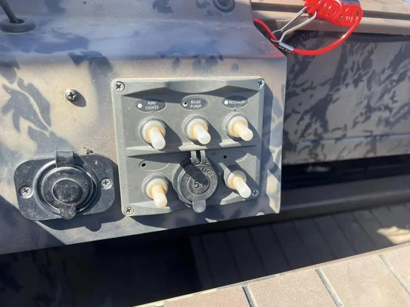 Slide: The Image of Control panel of a 2019 Pro-Line BTX 1848 boat with switches and charger port. - 12