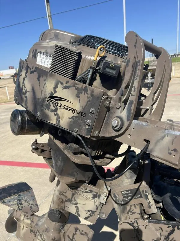 Slide: The Image of Camouflage-patterned Pro-Line BTX 1848 outboard motor, 2019 model, in a sunny outdoor setting. - 15