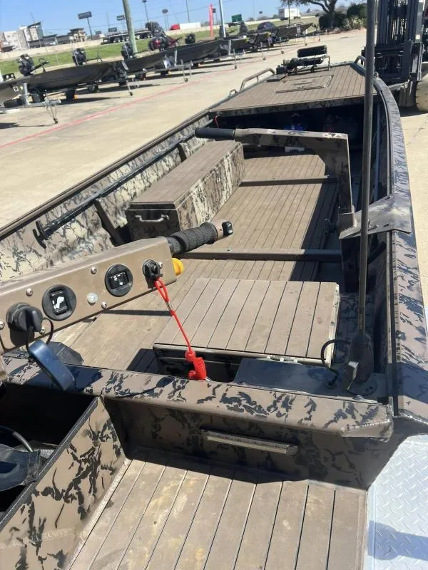 Slide: The Image of 2019 Pro-Line BTX 1848 boat interior with camouflage design, featuring seating and control panel. - 20