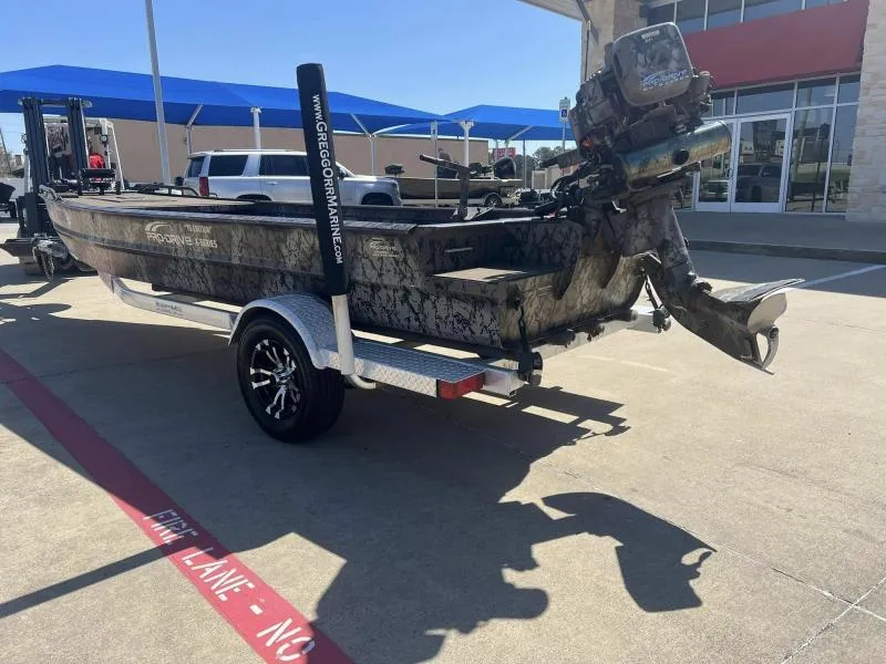 Slide: The Image of 2019 Pro-Line BTX 1848 boat on trailer, camo design, parked outdoors. - 3