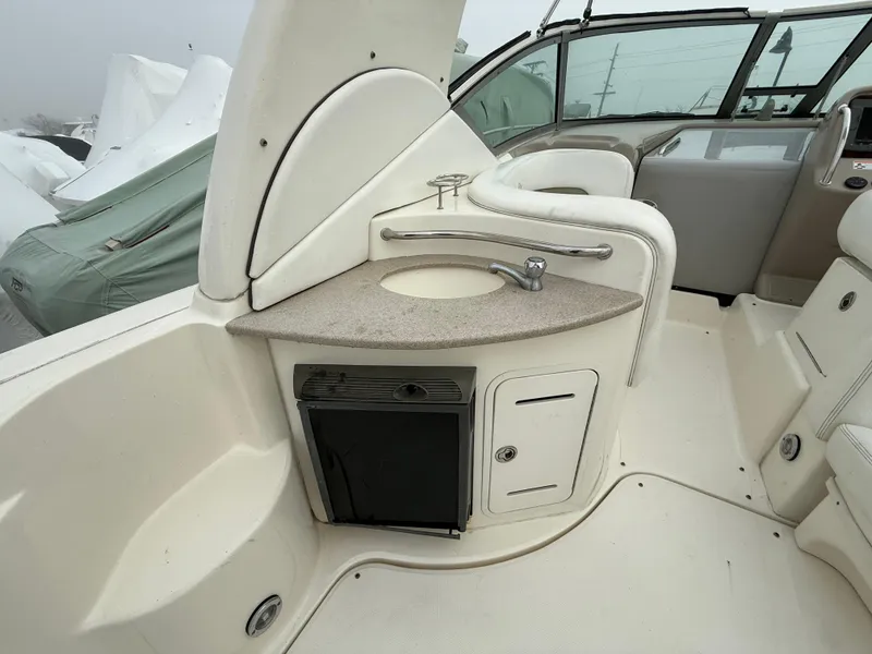 Slide: The Image of 2006 Sea Ray 320 Sundancer boat interior with sink and storage area. - 16