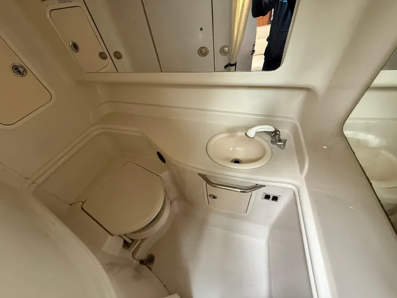Slide: The Image of Bathroom interior of 2006 Sea Ray 320 Sundancer yacht, featuring sink and toilet. - 25