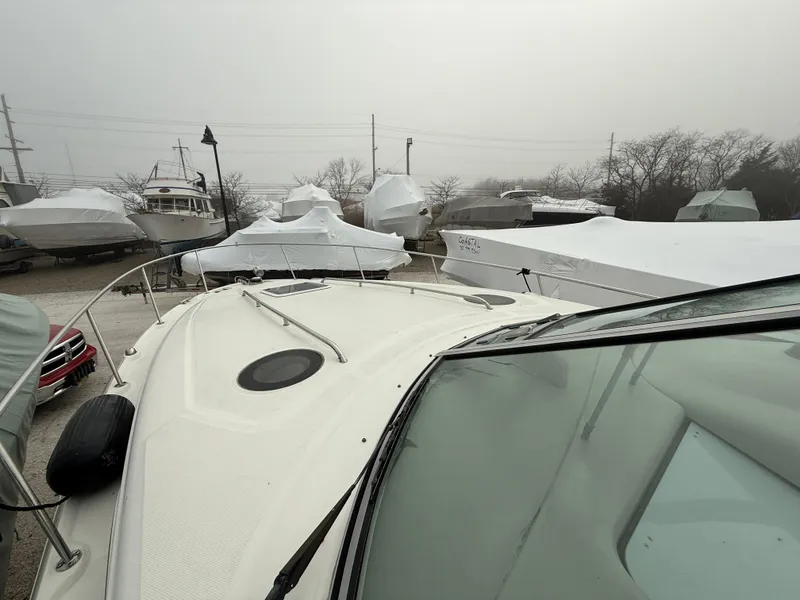 Slide: The Image of 2006 Sea Ray 320 Sundancer boat in storage, covered and surrounded by other boats. - 3