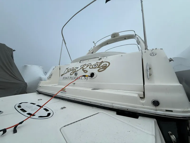 Slide: The Image of 2006 Sea Ray 320 Sundancer boat docked in foggy weather. - 33