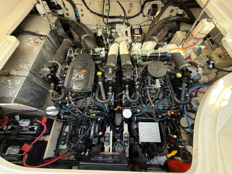 Slide: The Image of Engine compartment of a 2006 Sea Ray 320 Sundancer boat, showcasing dual engines and components. - 37