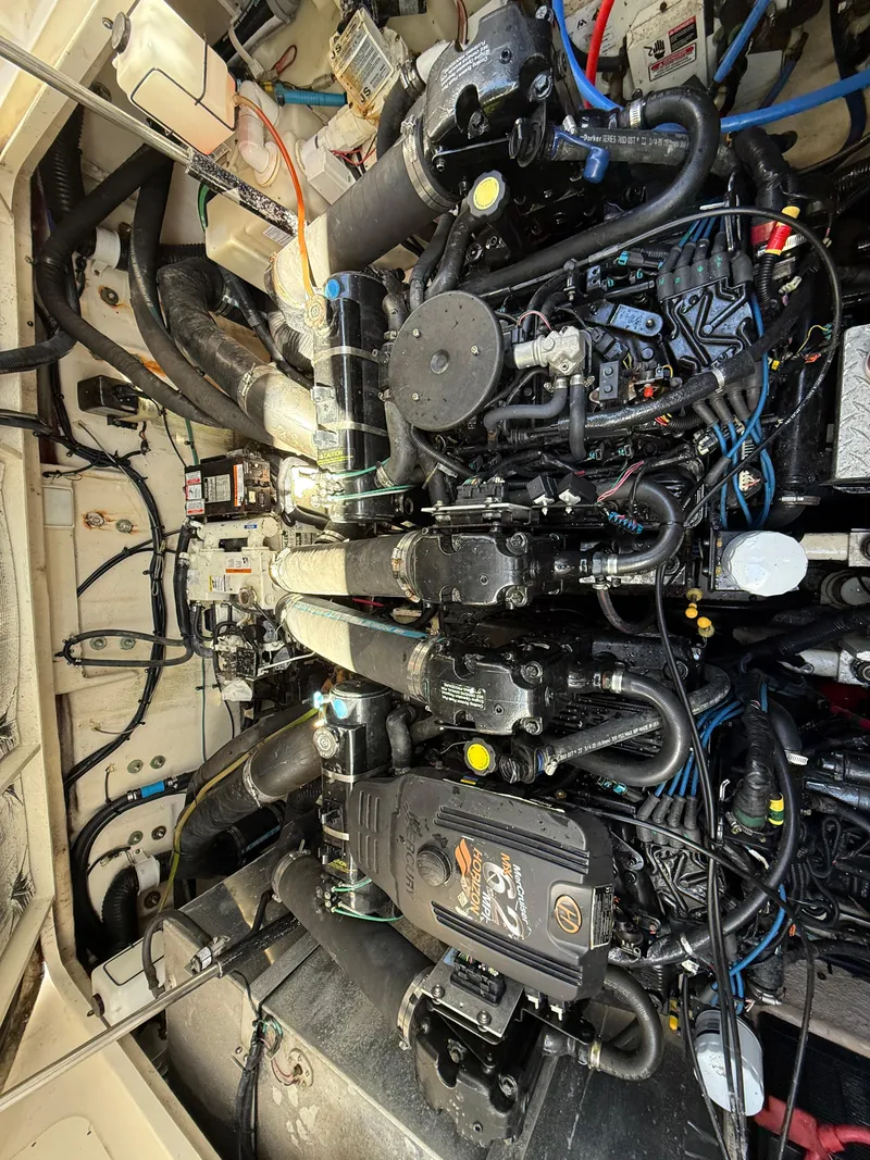 Slide: The Image of Engine room of 2006 Sea Ray 320 Sundancer, showcasing complex mechanical components. - 38