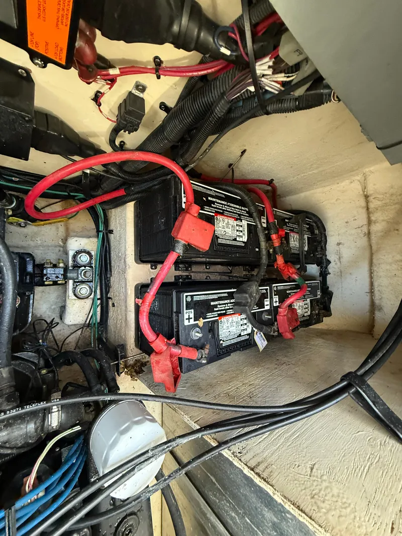Slide: The Image of Engine compartment of a 2006 Sea Ray 320 Sundancer showing batteries and wiring. - 39