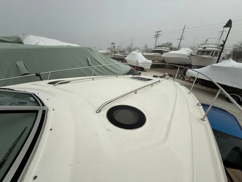 Slide: The Image of 2006 Sea Ray 320 Sundancer boat docked, covered for winter storage. - 4