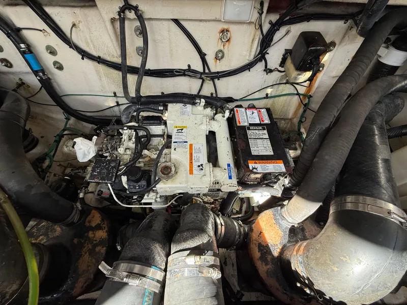 Slide: The Image of Engine compartment of a 2006 Sea Ray 320 Sundancer boat, showing mechanical components and wiring. - 40