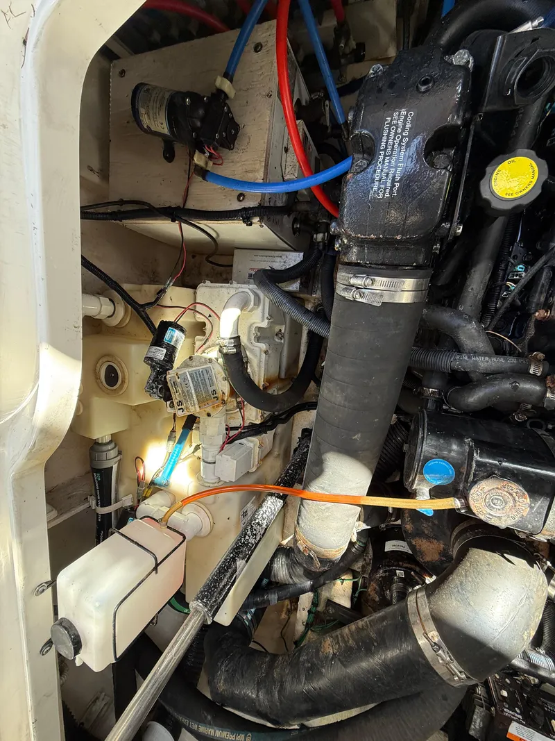 Slide: The Image of Engine compartment of a 2006 Sea Ray 320 Sundancer with visible wiring and components. - 41
