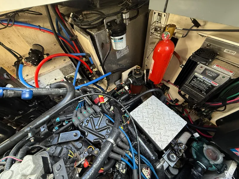 Slide: The Image of Engine compartment of a 2006 Sea Ray 320 Sundancer with visible wiring and components. - 42