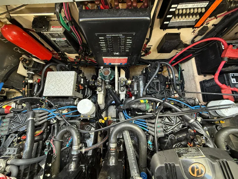 Slide: The Image of Engine compartment of a 2006 Sea Ray 320 Sundancer with visible wiring and components. - 43