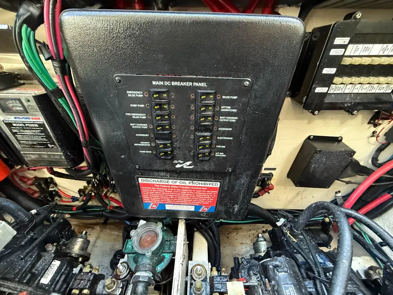 Slide: The Image of Engine room of 2006 Sea Ray 320 Sundancer with main DC breaker panel and wiring. - 44