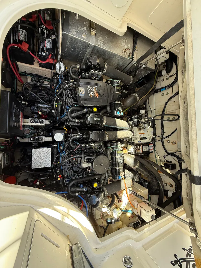 Slide: The Image of Engine compartment of a 2006 Sea Ray 320 Sundancer boat, showcasing complex machinery and wiring. - 47
