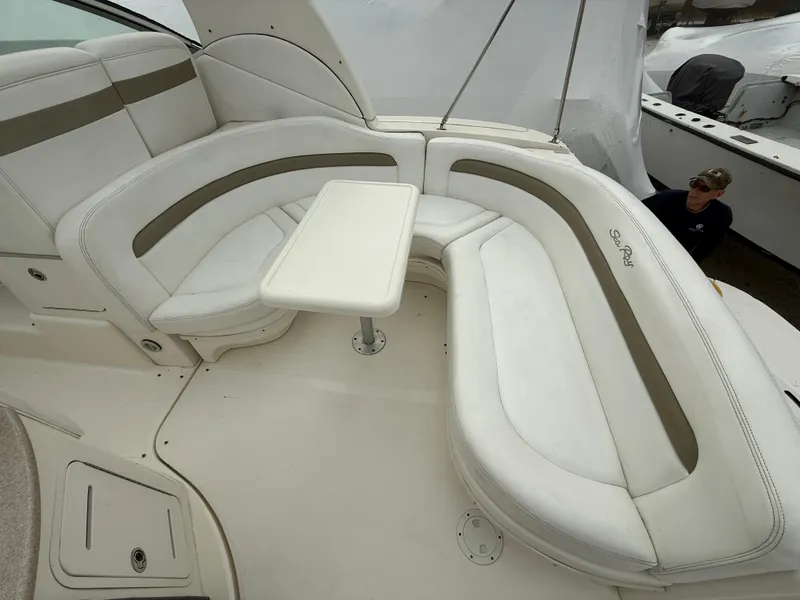 Slide: The Image of 2006 Sea Ray 320 Sundancer boat interior with white seating and table. - 9