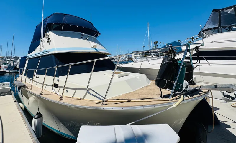Slide: The Image of 1978 Tollycraft 30 Sedan boat with modern Cummins 6bt diesel motors docked at marina. - 0