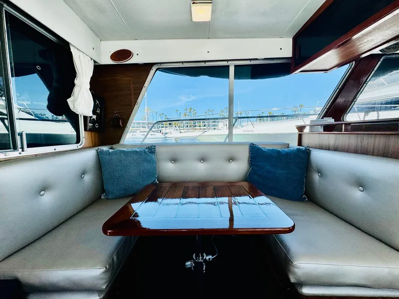 Slide: The Image of Interior of 1978 Tollycraft 30 Sedan with modern Cummins diesel, featuring a cozy dining area. - 12