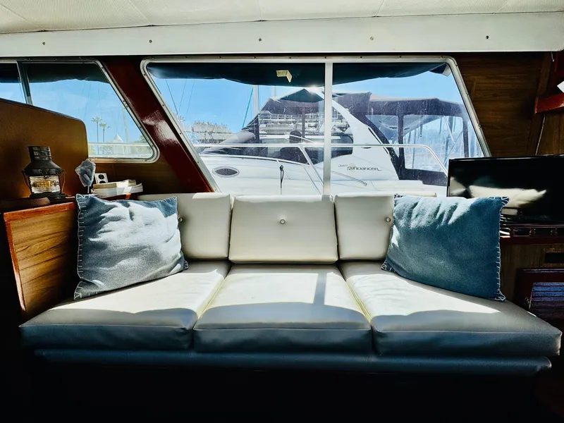 Slide: The Image of Interior of 1978 Tollycraft 30 Sedan with modern Cummins 6bt diesel motors, featuring a cozy sofa. - 13
