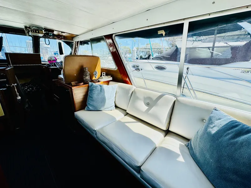 Slide: The Image of Interior of 1978 Tollycraft 30 Sedan with modern Cummins 6bt diesel motors, featuring white seating. - 14