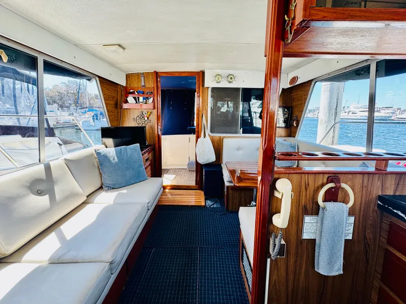 Slide: The Image of Interior of 1978 Tollycraft 30 Sedan with modern Cummins 6bt diesel motors, featuring cozy seating. - 19