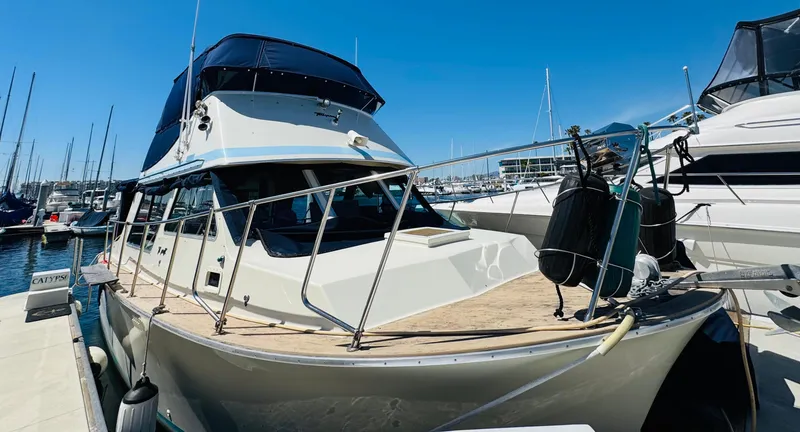 Slide: The Image of 1978 Tollycraft 30 Sedan boat with modern Cummins 6bt diesel motors docked at marina. - 2