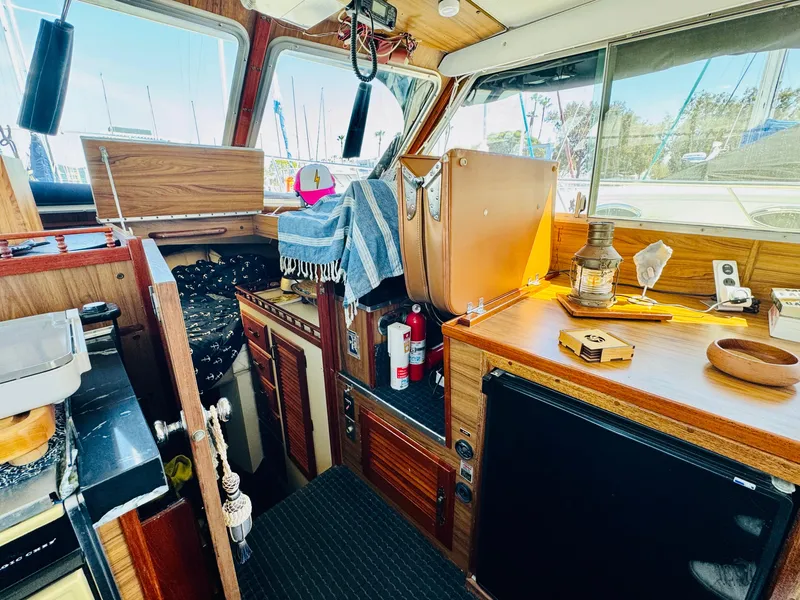Slide: The Image of 1978 Tollycraft 30 Sedan interior with modern Cummins 6bt diesel motors, featuring wood accents and nautical decor. - 20