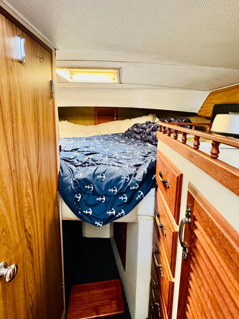 Slide: The Image of 1978 Tollycraft 30 Sedan cabin interior with cozy bed and wooden cabinetry. - 21