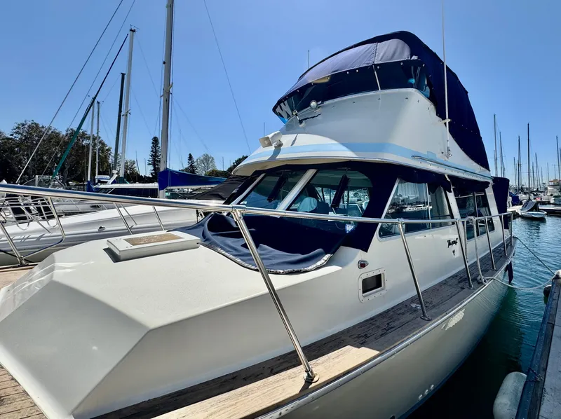 Slide: The Image of 1978 Tollycraft 30 Sedan with modern Cummins 6bt diesel motors docked at marina. - 3