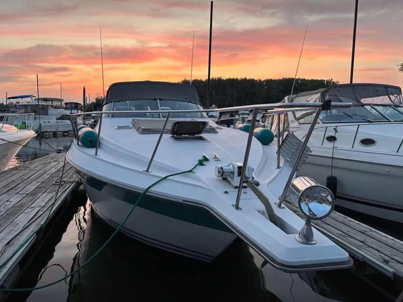 Slide: The Image of 1989 Regal Commodore 360 docked at sunset, surrounded by other boats. - 1