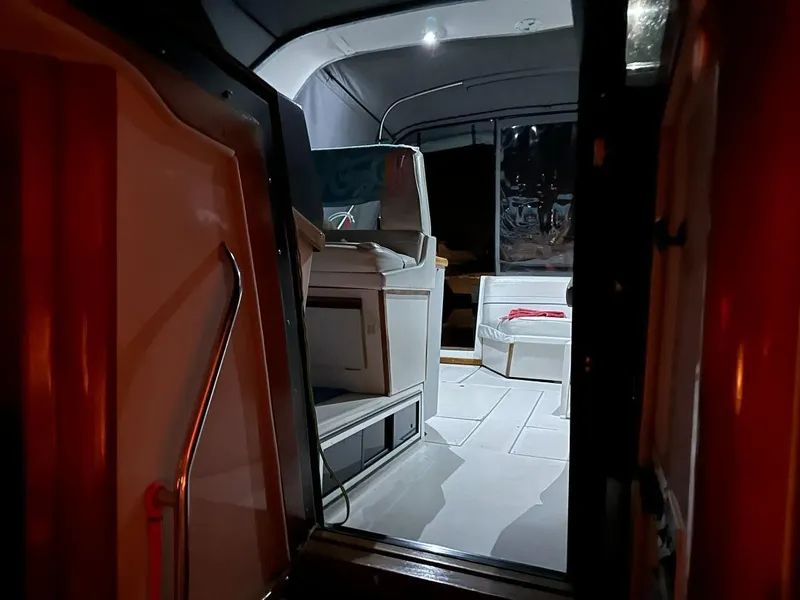 Slide: The Image of Interior view of 1989 Regal Commodore 360 boat, featuring seating and ambient lighting. - 10