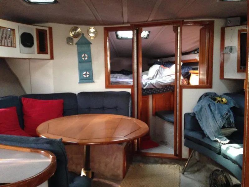 Slide: The Image of Interior of a 1989 Regal Commodore 360 yacht with cozy seating and wooden accents. - 15